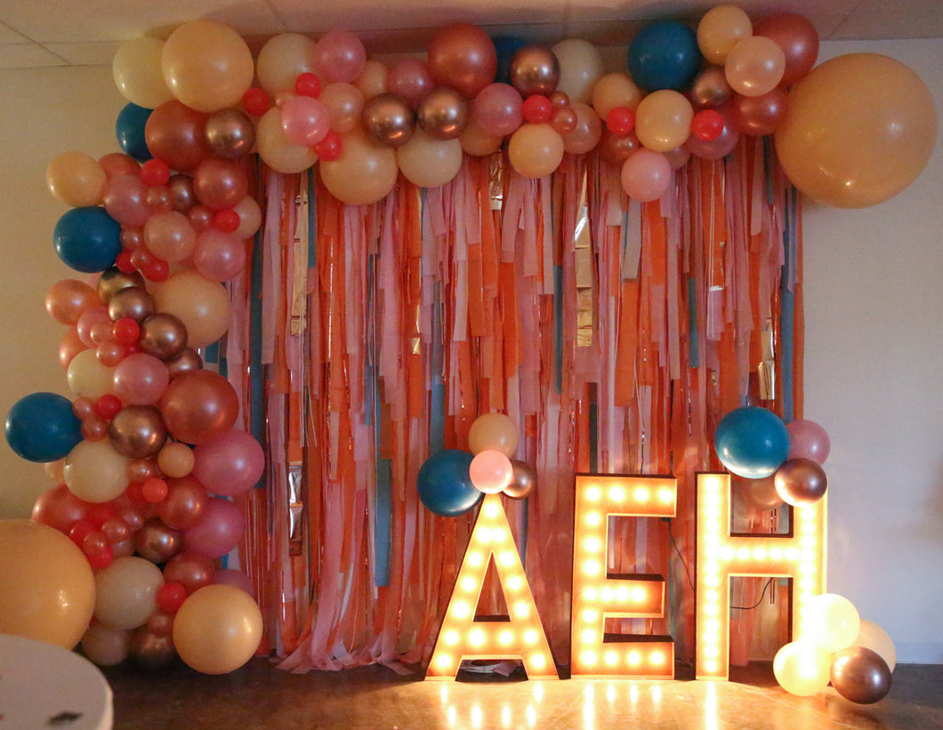 Custom Installs Organic Arch with Fringe Backdrop